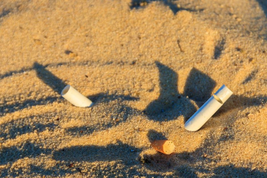 bigstock Cigarette Butts In Yellow Sand 438705281