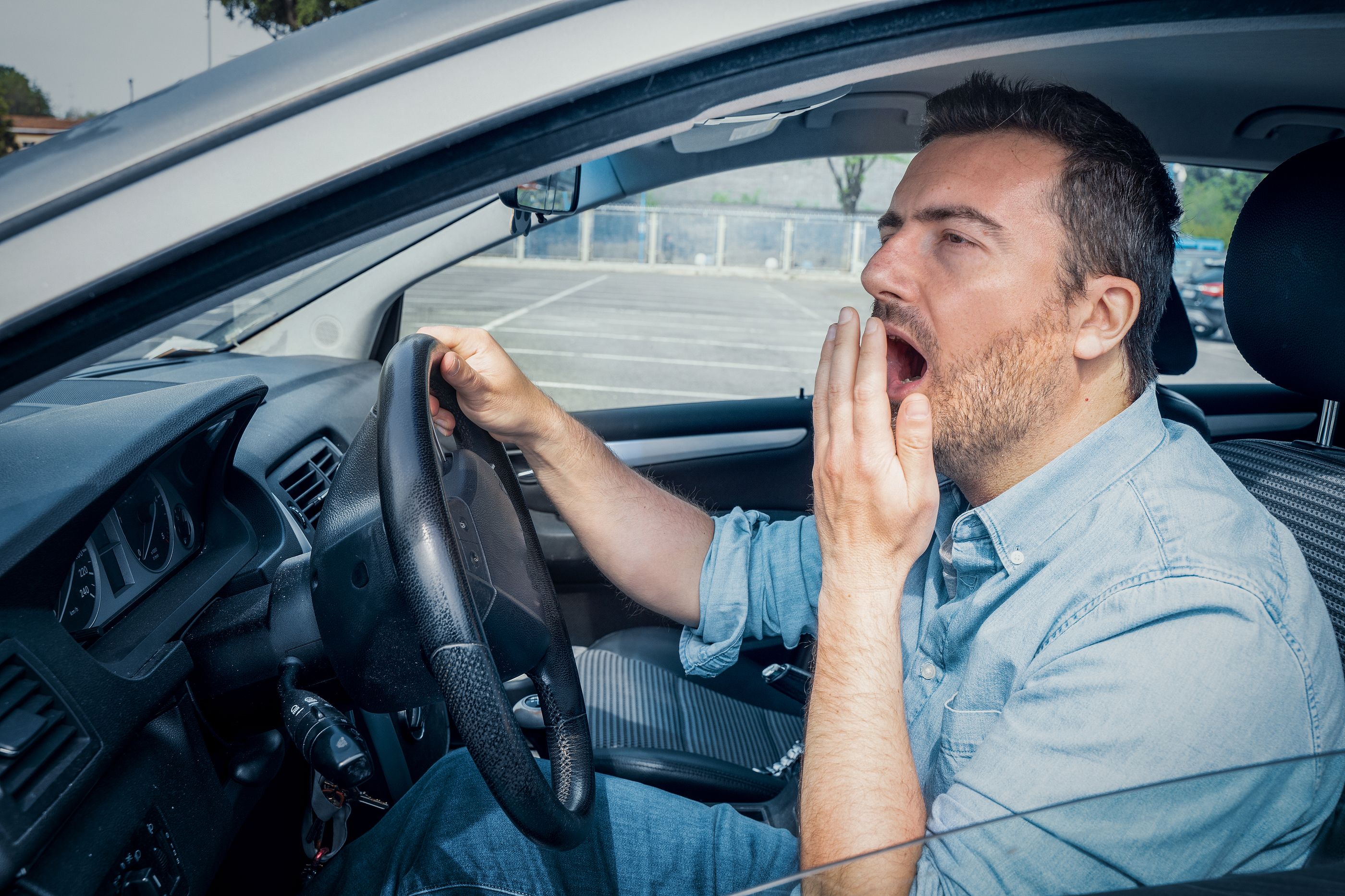 bigstock One Sleepy Driver Yawning And  454335021