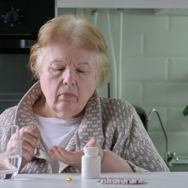 bigstock Senior Woman Takes Pills At Ho 460064391