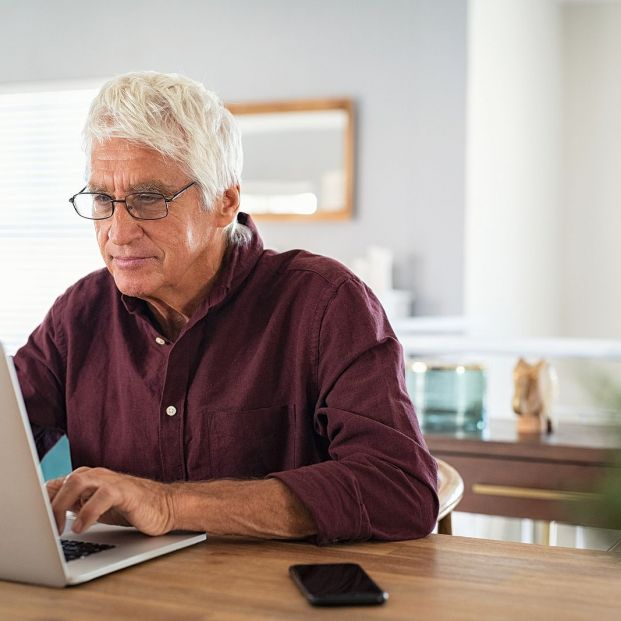 bigstock Old man working on laptop at h 377224903