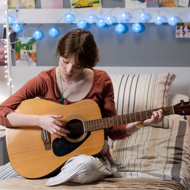 bigstock Teenage girl playing guitar wh 447457825