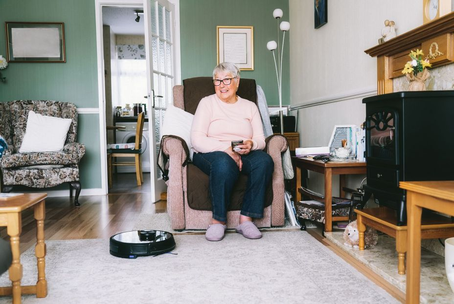 bigstock Senior Woman Using A Robot Vac 458301595