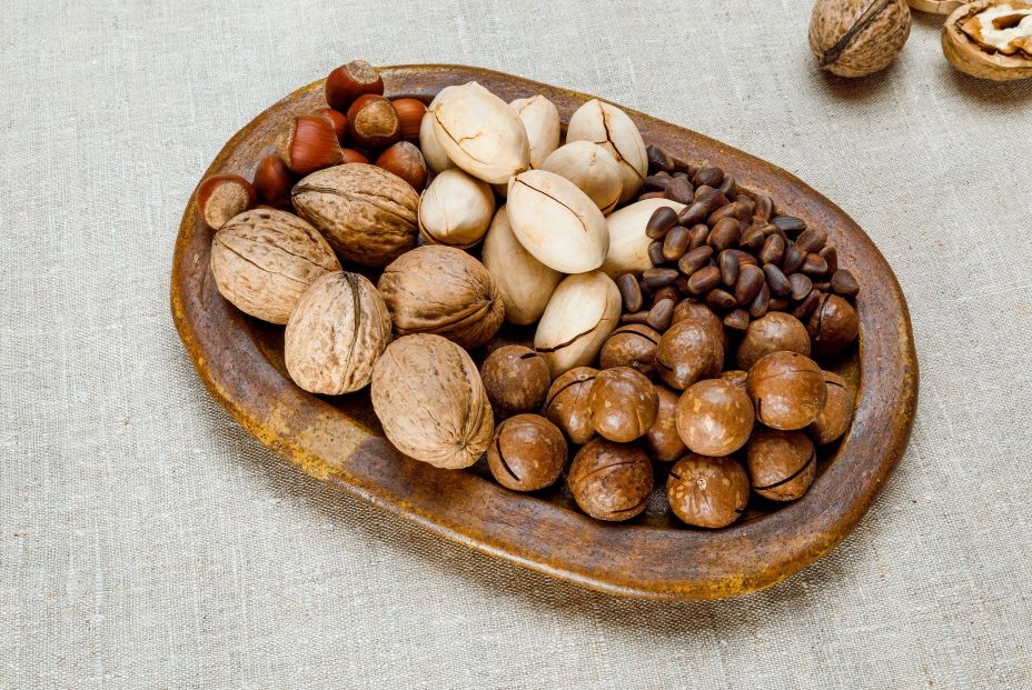 bigstock A Variety Of Nuts On A Clay Pl 470463173