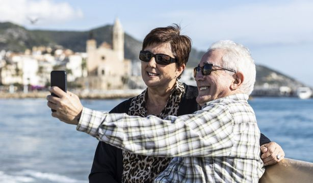 bigstock Two Seniors Using A Mobile In  334460494