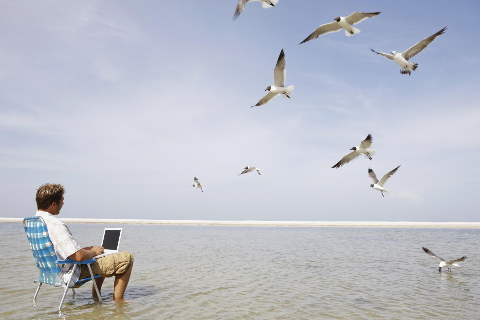 3736 Man using laptop in middle of water (1)