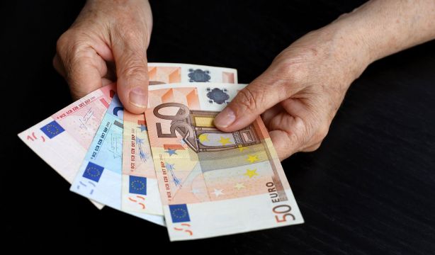 bigstock Elderly Woman With Euro Notes  455741875