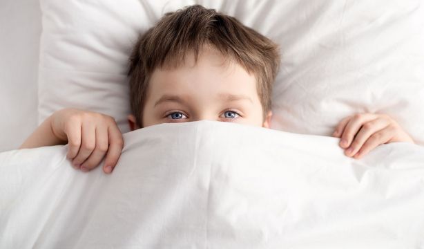 bigstock Little Boy In Bed Covering His 120298484