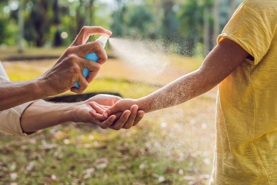 bigstock Dad And Son Use Mosquito Spray 235762357