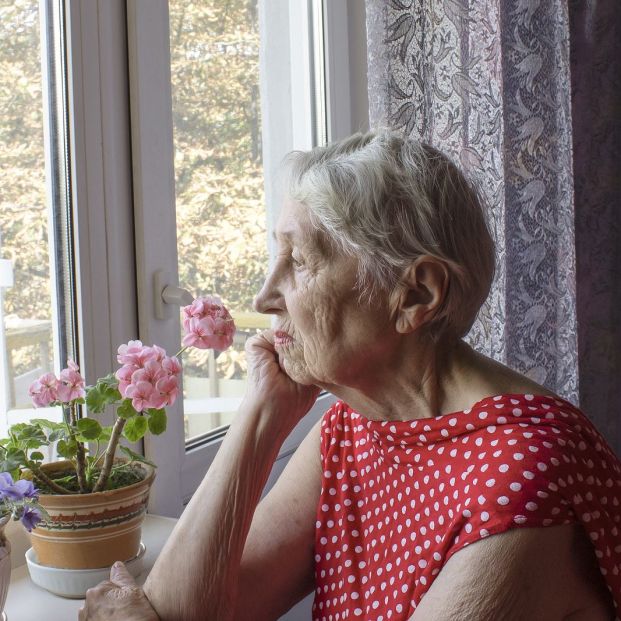bigstock Old Lonely Woman Sitting Near  320536210