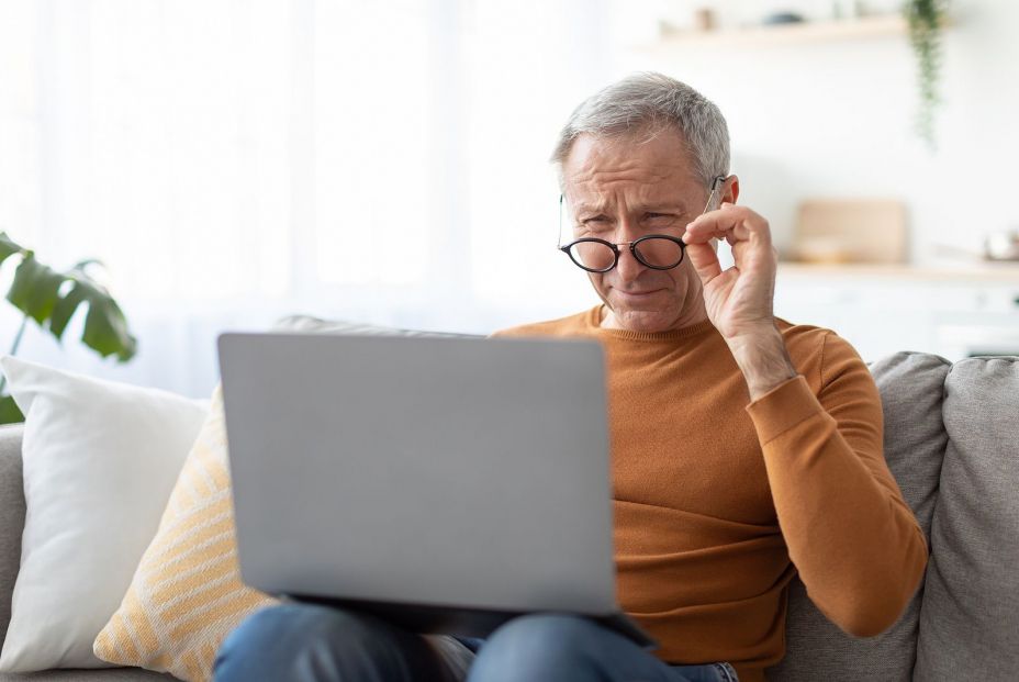 bigstock Mature Man Squinting Using Lap 450172461