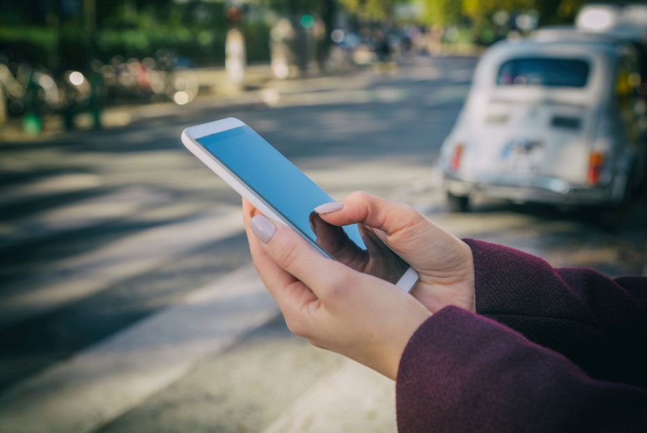 bigstock Woman Using Cellphone And Cros 227012695