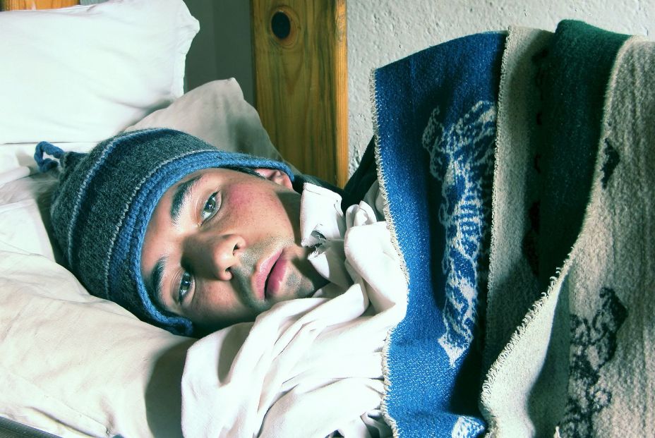 bigstock Young man in a bed feeling col 605419