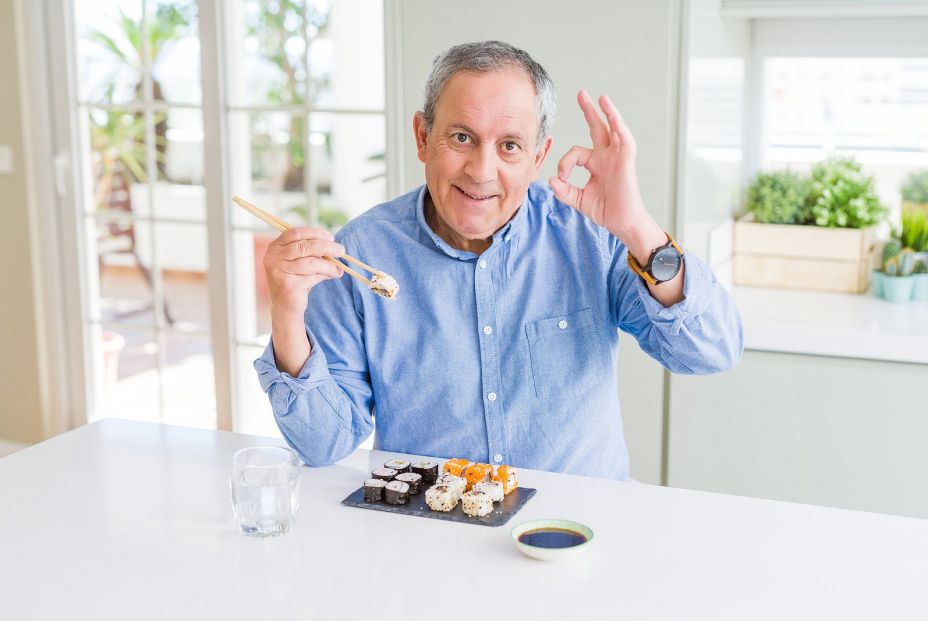 bigstock Handsome senior man eating tak 313350310