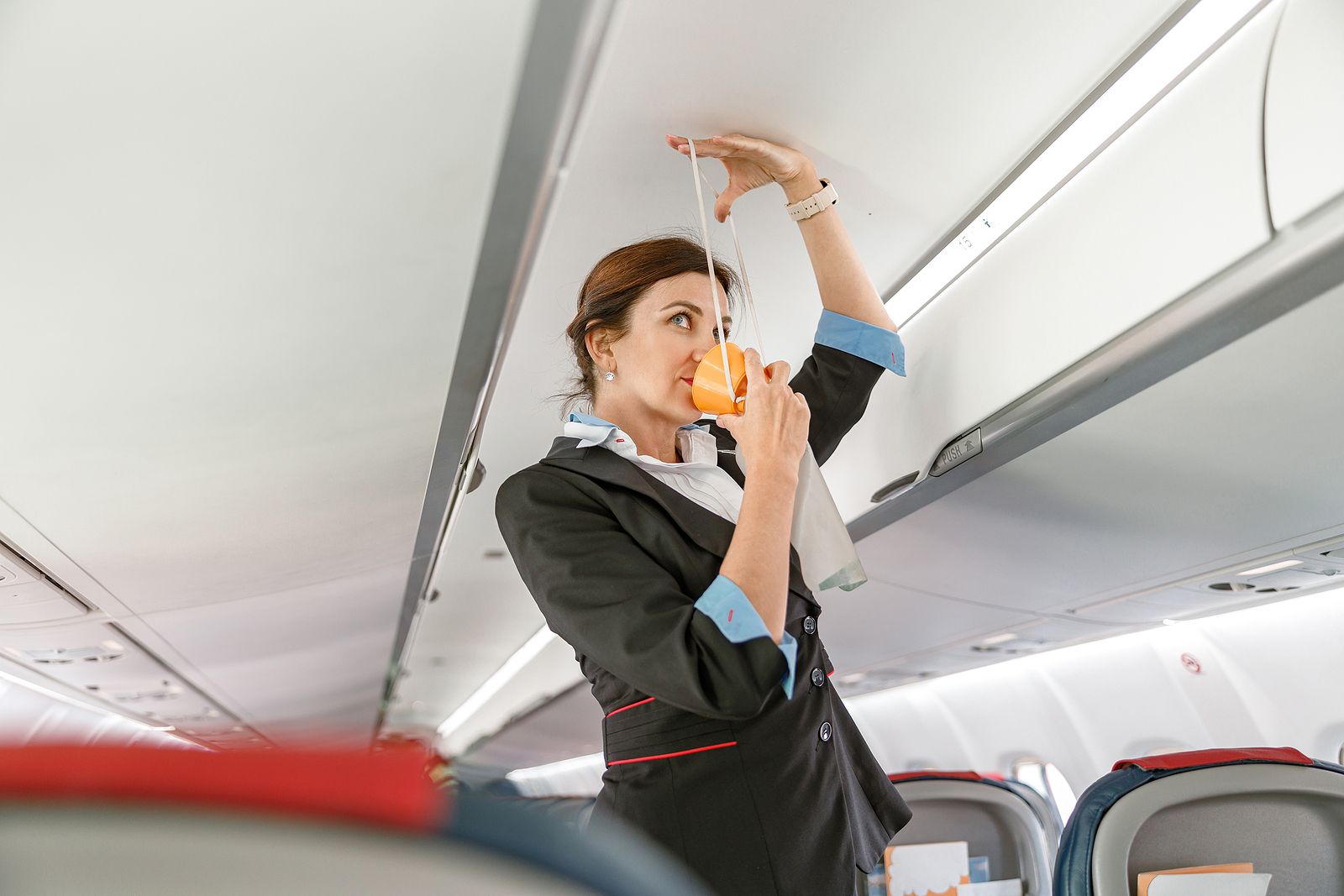 bigstock Flight Attendant Demonstrating 446386667