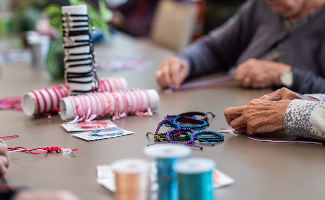 Mayores en residencias confeccionan pulseras para financiar tratamiento para niños con cáncer