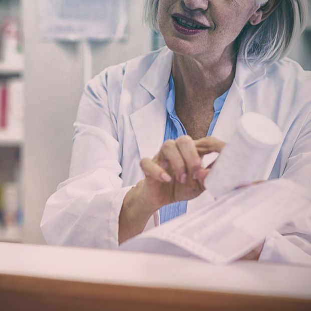 bigstock Pharmacist assisting the bottl 269160346