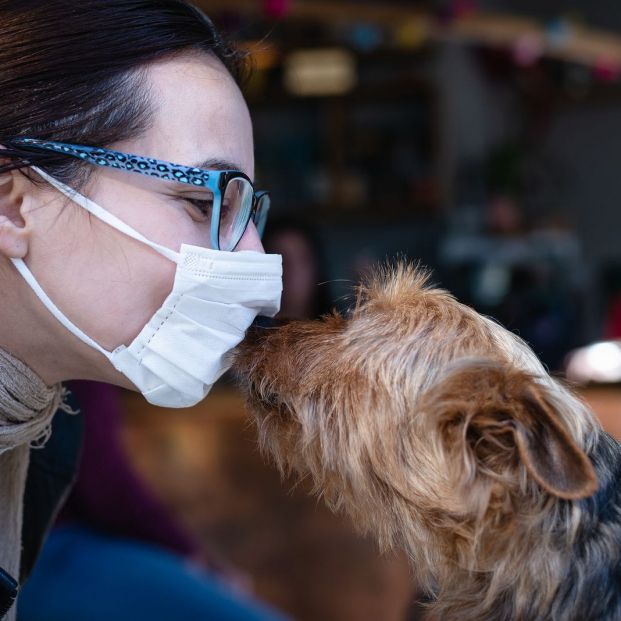 bigstock Woman With Mask Kissing Dog W 356348000