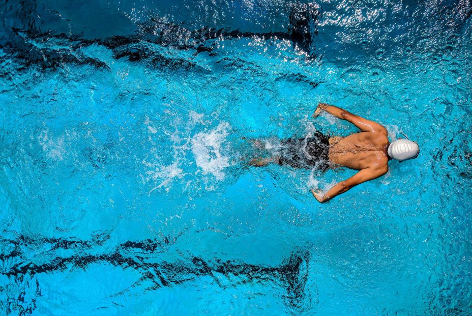 person swimming on body of water 