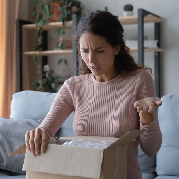 bigstock Angry Confused Woman Unpacking 371339233