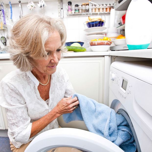 bigstock Senior woman loading washing m 170692190