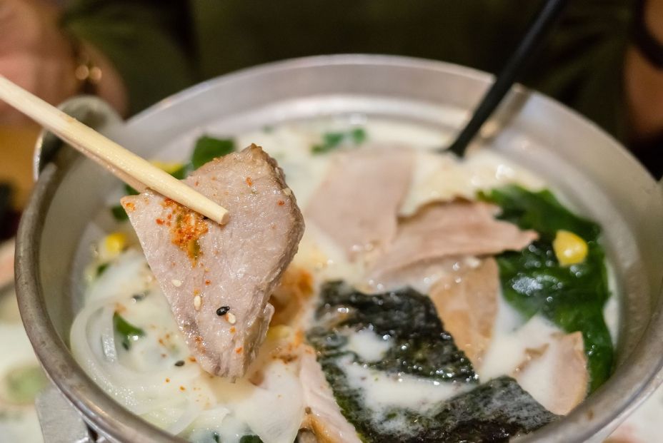 bigstock woman eat a bowl of tonkotsu r 366687592