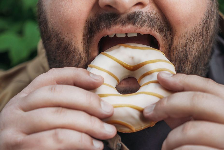 bigstock Fat Man Eats Donut On Street  367816150