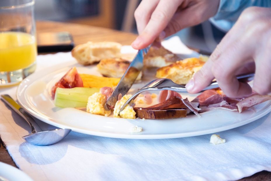 bigstock Close Up Of Hands Cutting Food 345711856