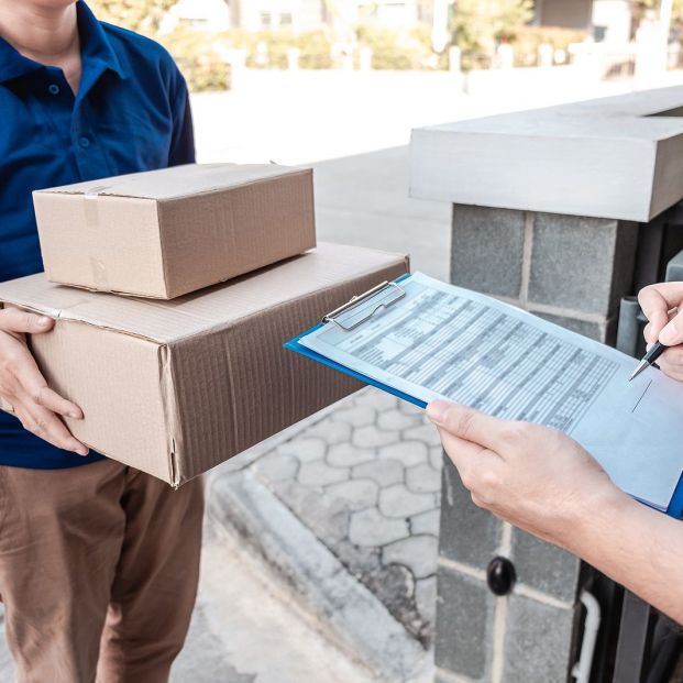 bigstock Young Delivery Man Deliver Box 345968419