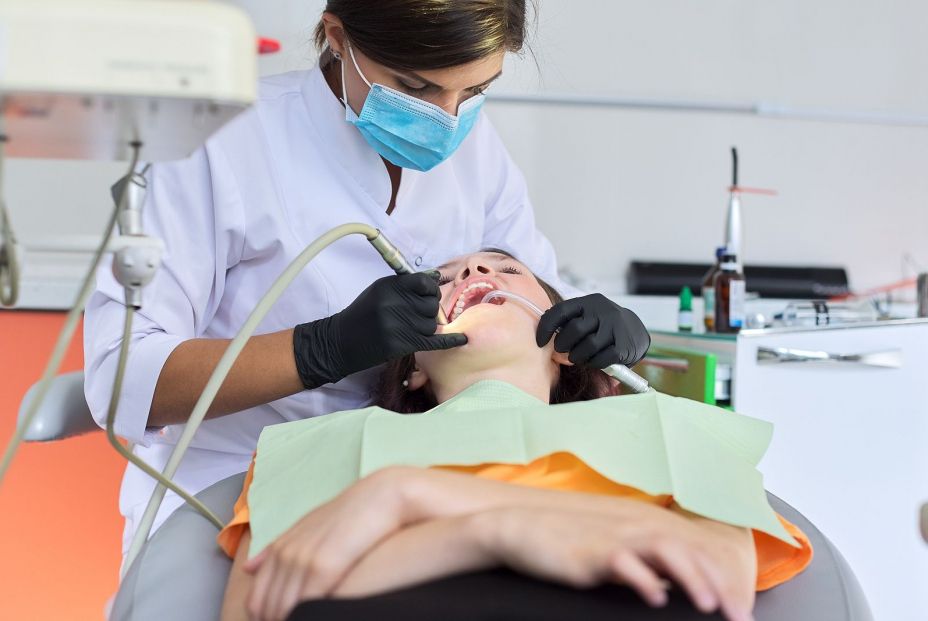 bigstock Woman Doctor Dentist Treating  358368401