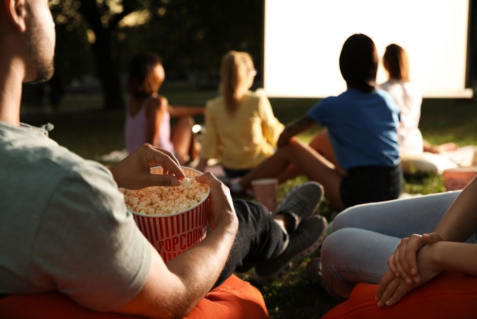 bigstock Young People With Popcorn Watc 324858640