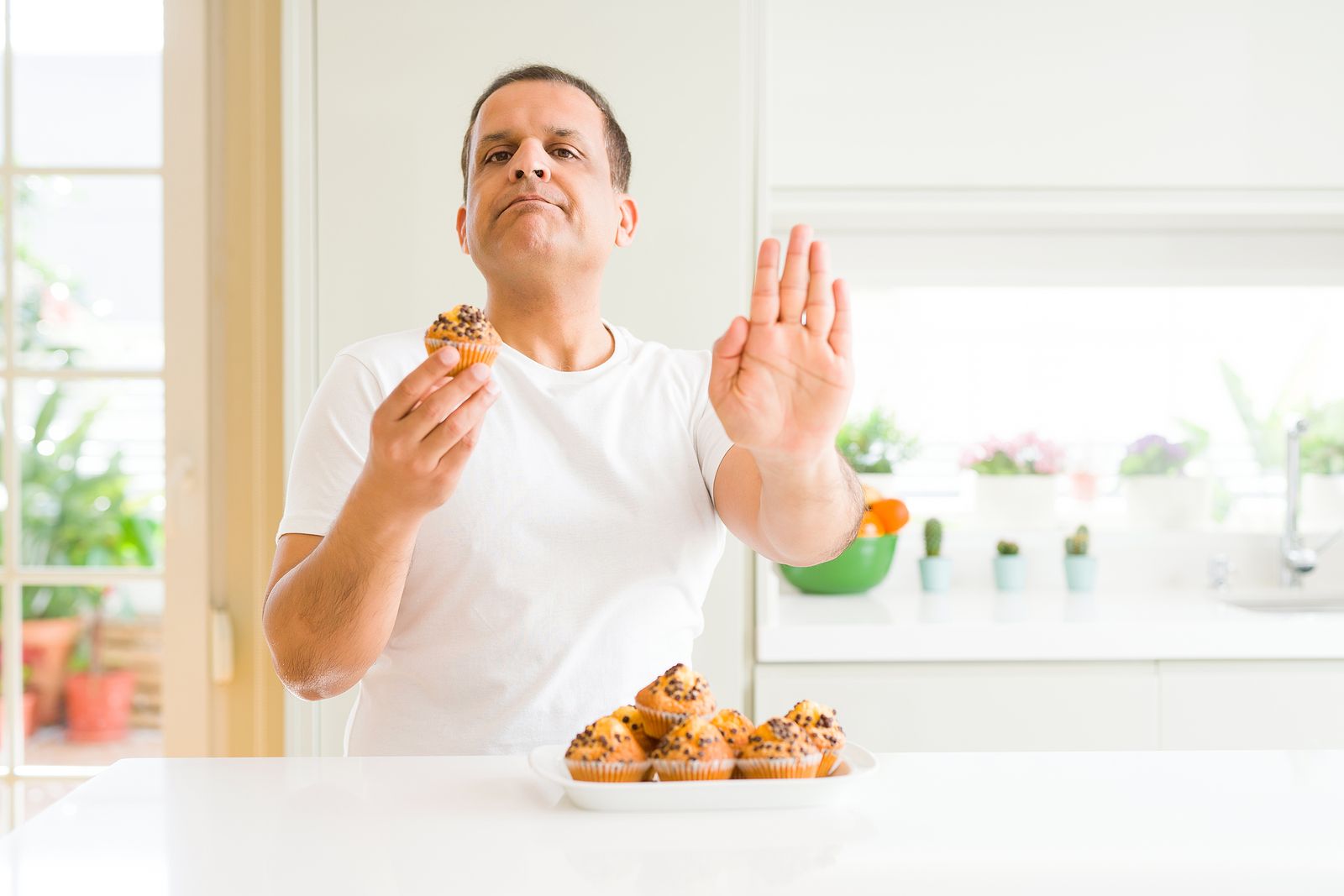 bigstock Middle age man eating chocolat 287942368