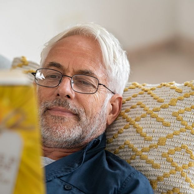 bigstock Happy mature man reading a boo 363994552