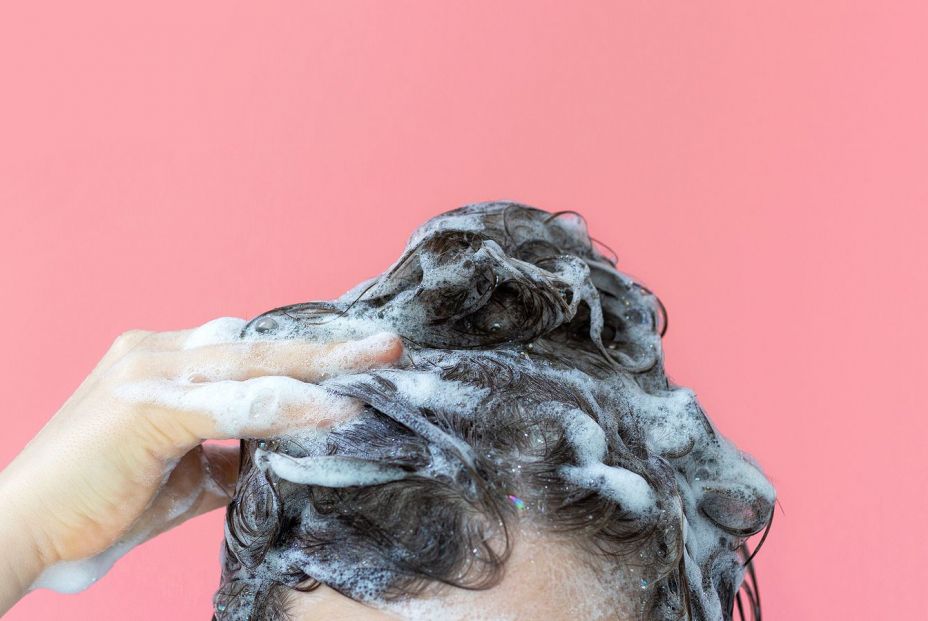 bigstock A Girl Washes Her Hair With Sh 381445583