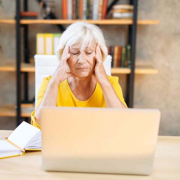 bigstock An Elderly Woman Holding Head  386190547