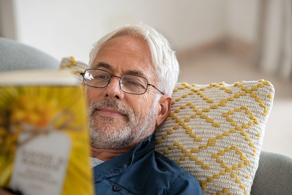 bigstock Happy mature man reading a boo 363994552