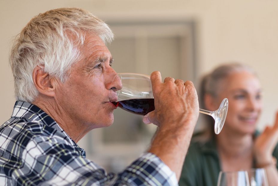 bigstock Happy senior man drinking a gl 306450988