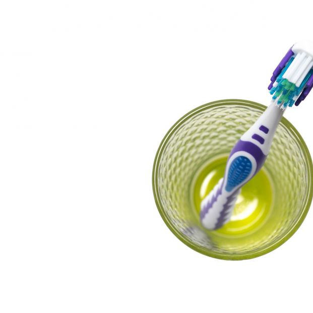 bigstock A Toothbrush In A Glass The C 392580287 bigstock A Toothbrush In A Glass The C 392580287
