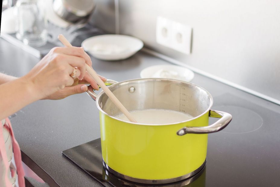 bigstock Woman Preparing Bechamel Sauce 335573575