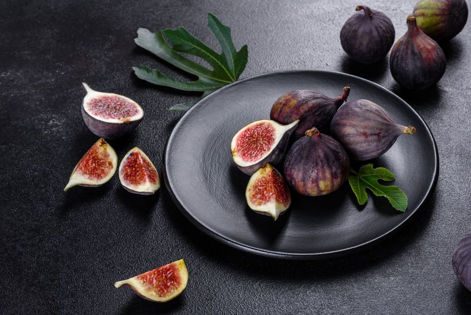 bigstock Fresh Ripe Figs On A Dark Conc 384836537