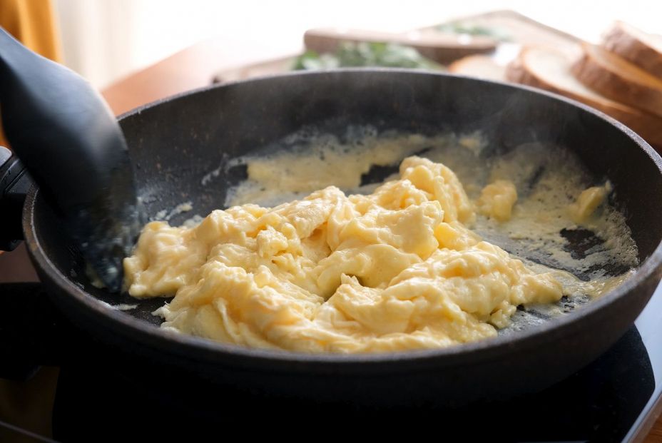 bigstock Scrambled Eggs In Cooking Pan  384398342