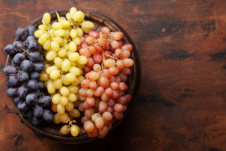 bigstock Various grapes on old wooden b 398333861