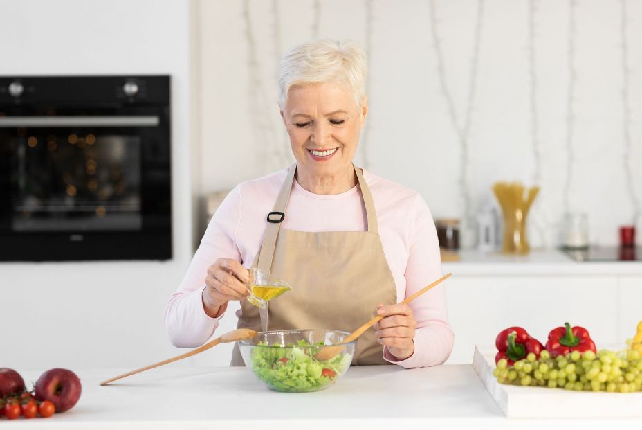 bigstock Smiling Aged Woman Cooking Veg 399615461