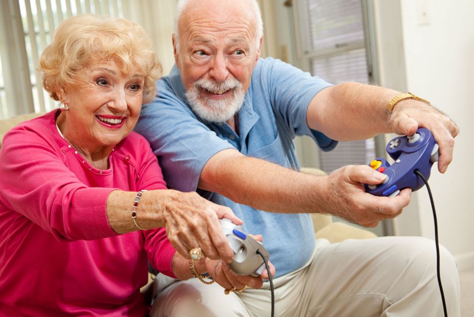 Adultos jugando a videojuegos (bigstock)