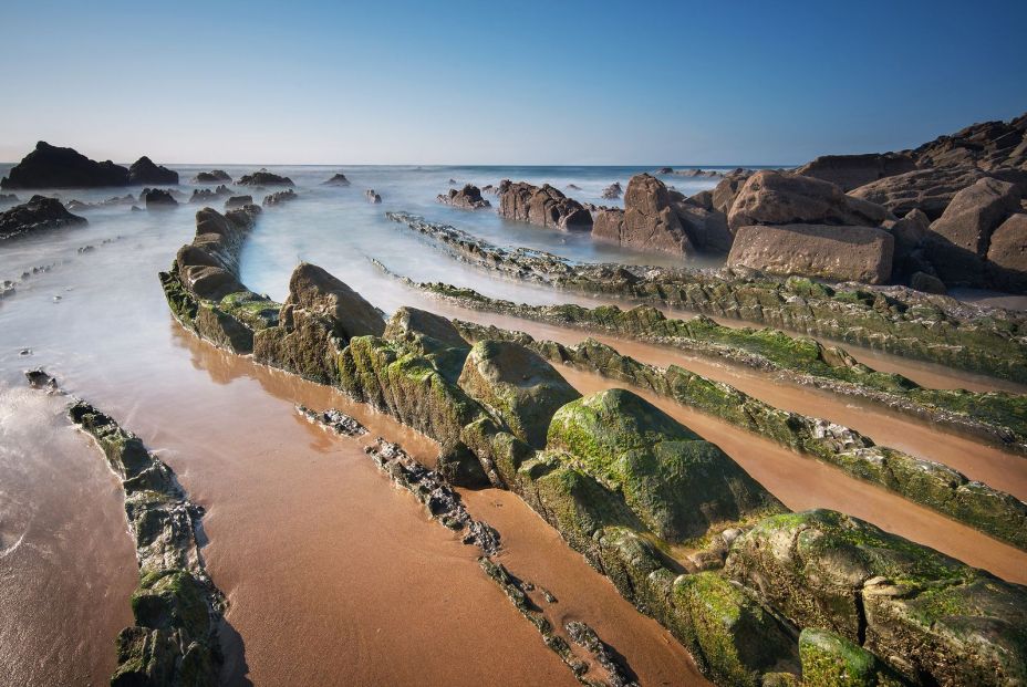 bigstock Barrika Beach Mossy Rocks Bil 182004442