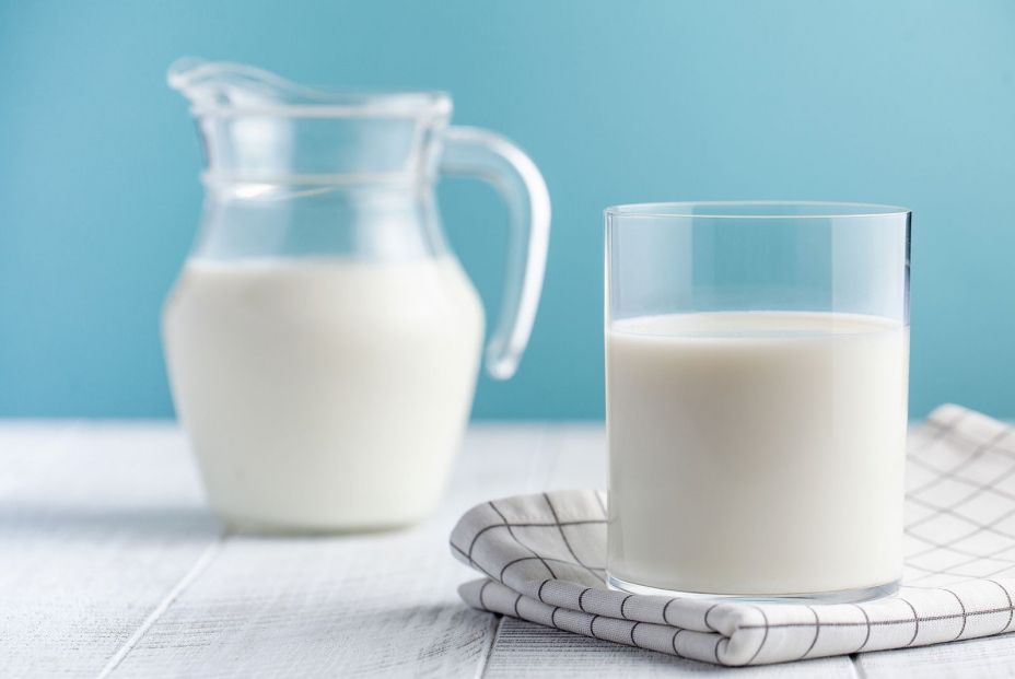 bigstock Glass And Jug Of Milk On A Blu 368289604