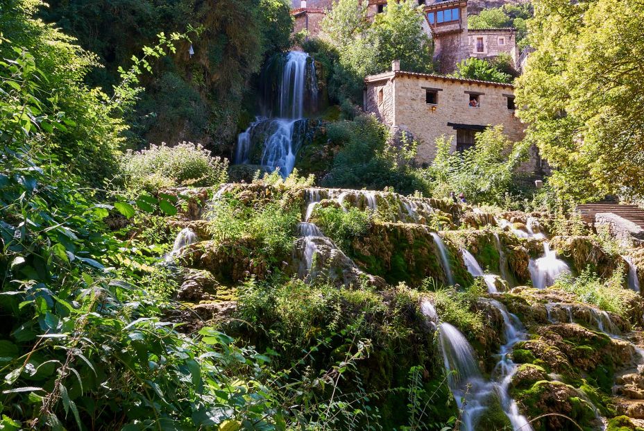 bigstock Waterfall At Orbaneja Del Cast 259890484