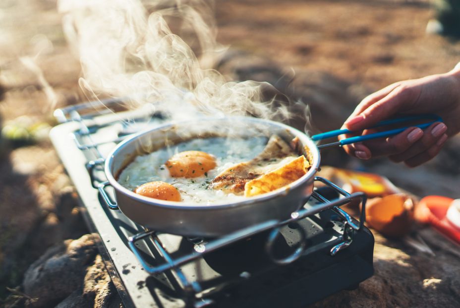 bigstock Person Cooking Fried Eggs In N 349882912